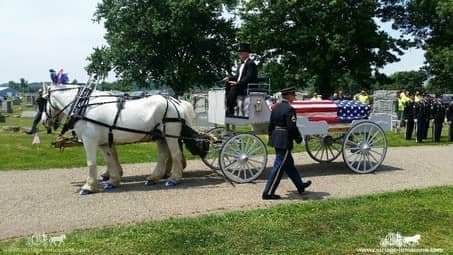 Caisson Hearse passing mourners at a funeral in Coshocton, OH