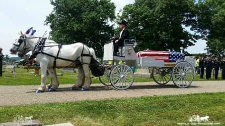 Caisson Hearse on cemetery grounds at a funeral in Coshocton, OH