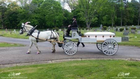 Horse-drawn Caisson Hearse leading a funeral procession in Akron, OH