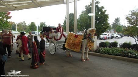 Groom waving from the Indian Wedding Carriage at La Centre in Westlake, OH